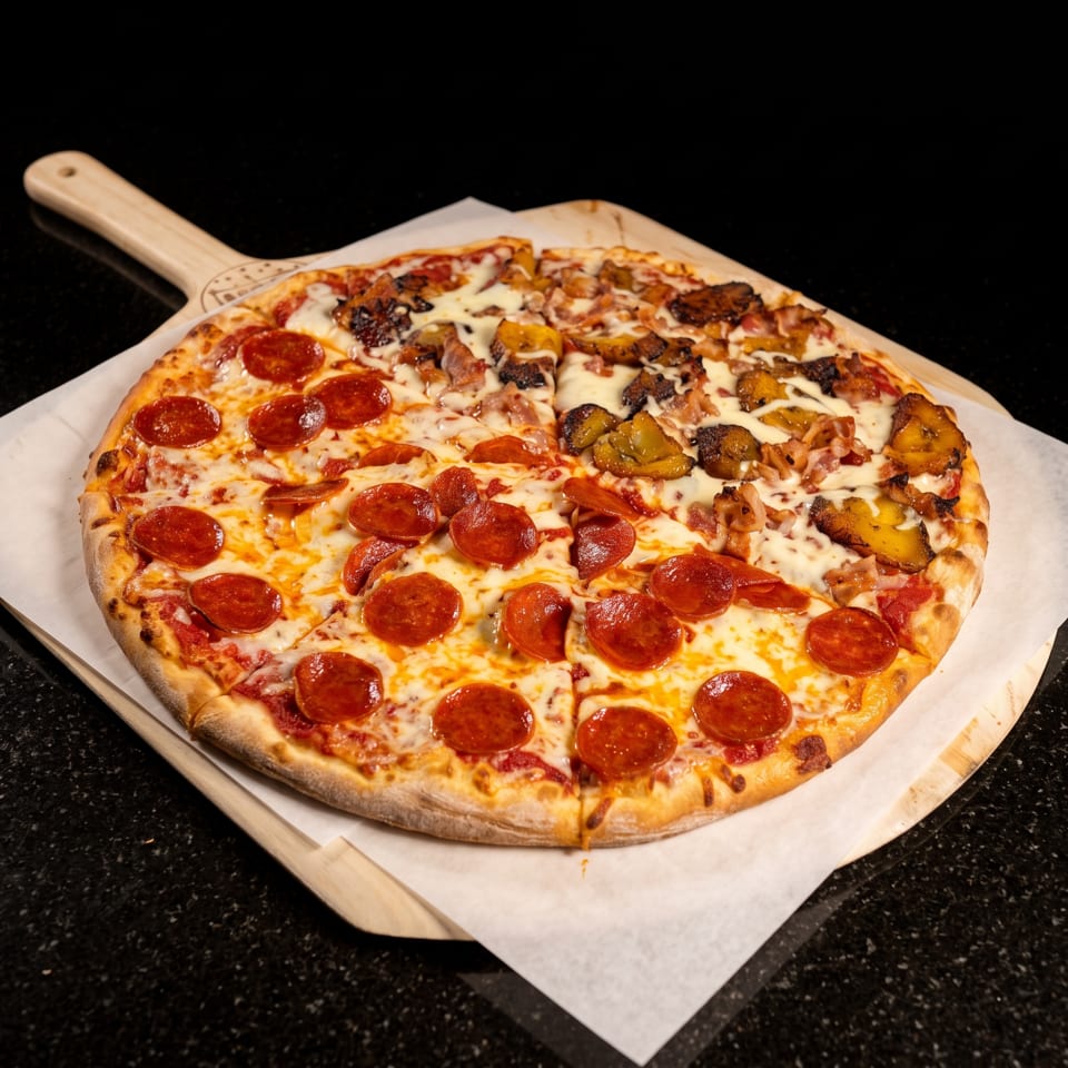 Large cheesy pizza topped with pepperoni, sausage, bacon, and roasted vegetables on a wooden serving peel.